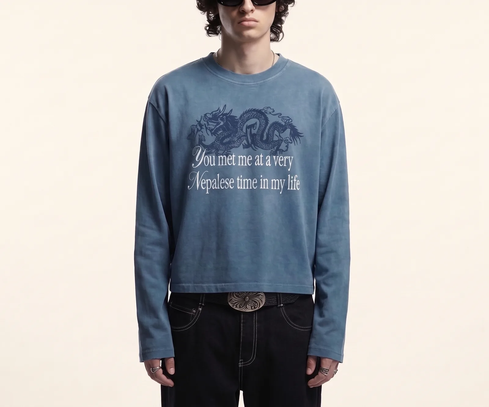 Model wearing the dusty blue longsleeve with a navy dragon print